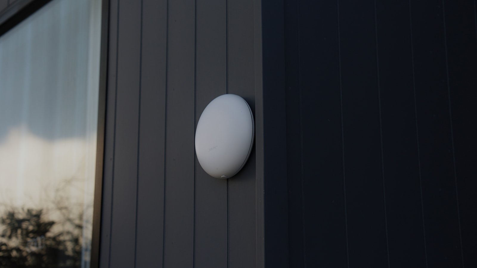 The Outdoor Halo on dark timber cladding beside a window
